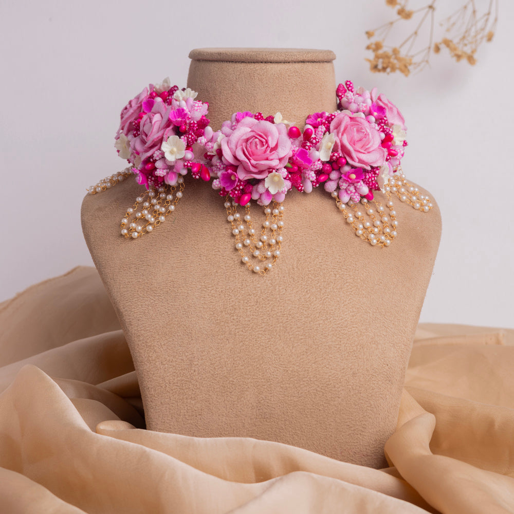 Pink Rose Flower and Shell Haldi Jewellery Set on display, featuring delicate pearls and vibrant florals, ideal for weddings.
